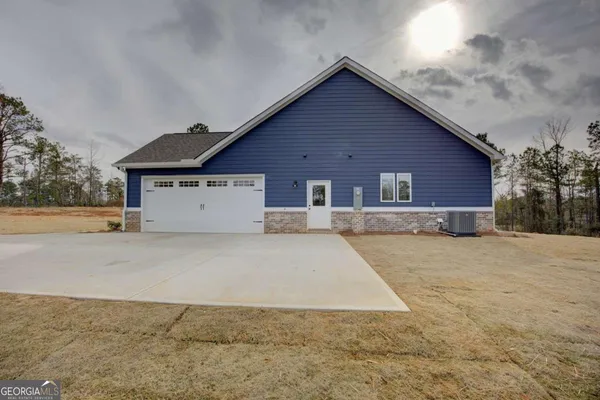 a view of a house with a yard and garage