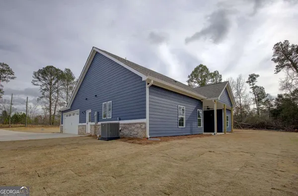 a view of a house with a yard and garage