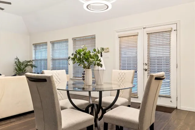 a dining room with furniture and wooden floor