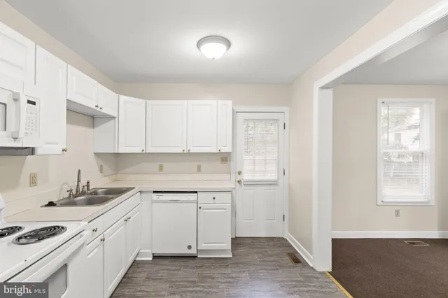 a kitchen with a sink cabinets and window