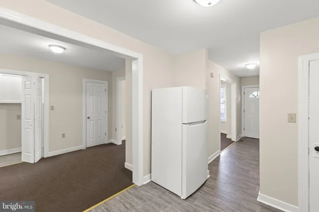 a view of hallway with wooden floor