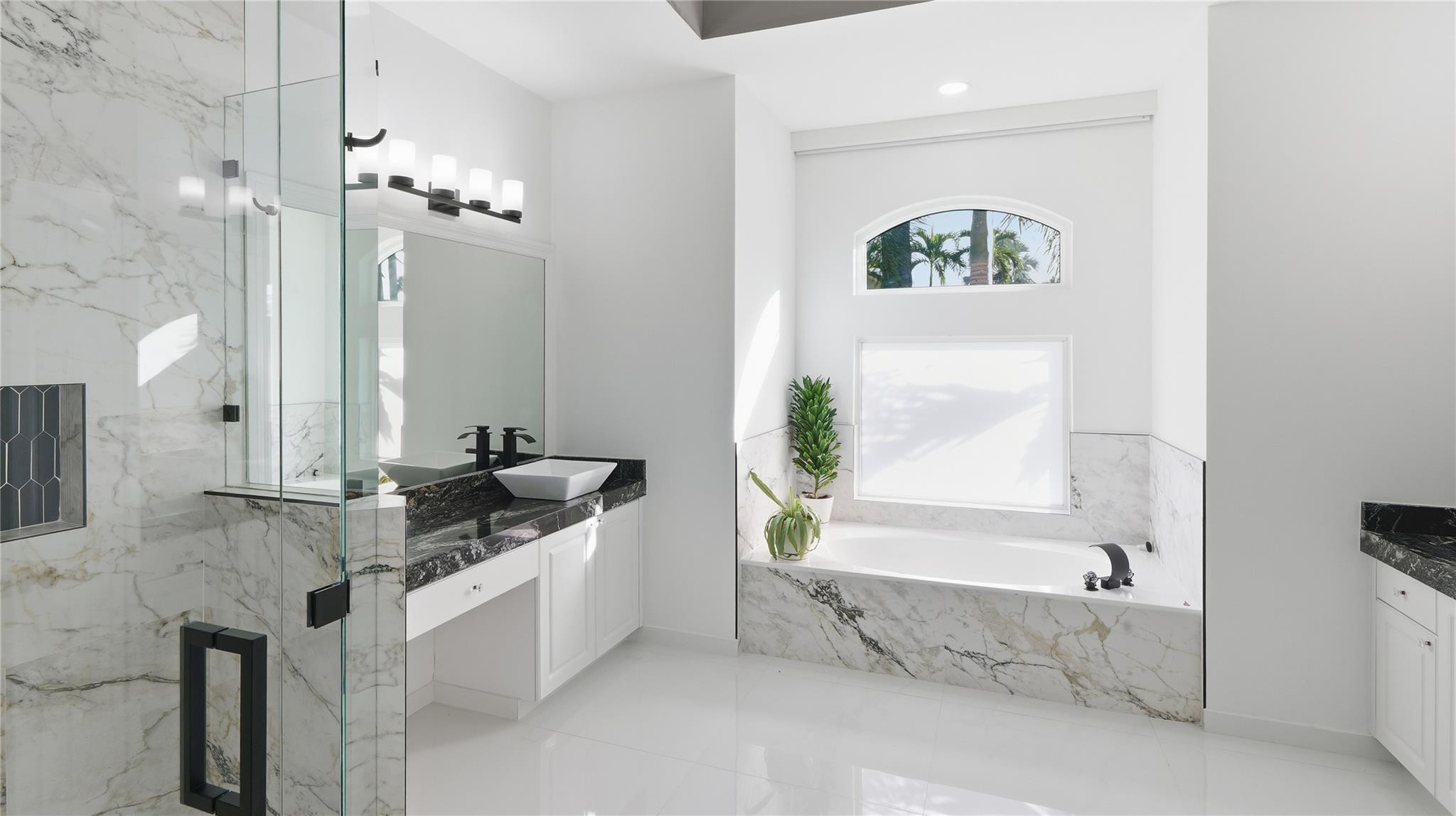 10141 Umberland Place Boca Raton, FL 33428 - Photo 18 of 26 a spacious bathroom with a bathtub sink and mirror