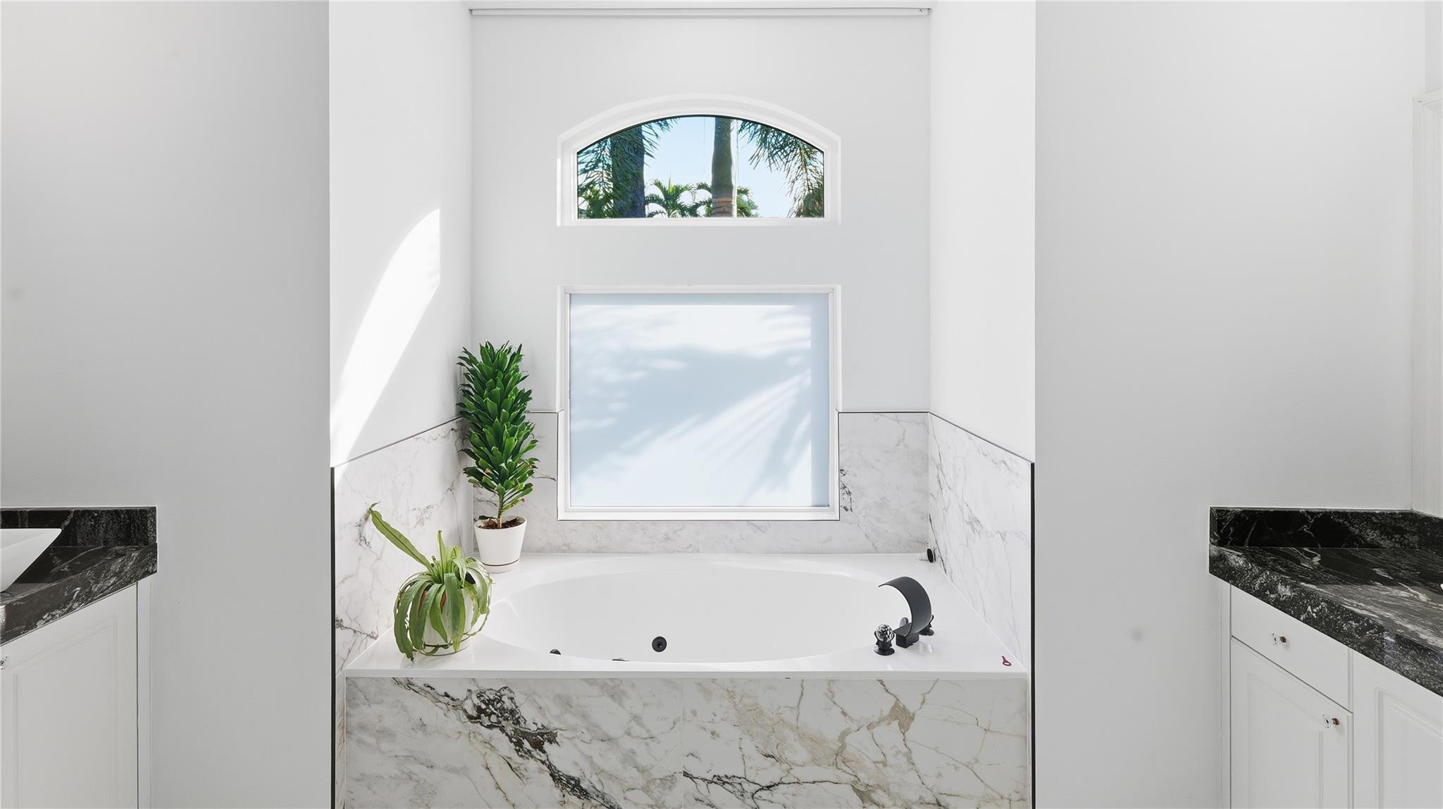 10141 Umberland Place Boca Raton, FL 33428 - Photo 20 of 26 a bathroom with a bathtub and a window