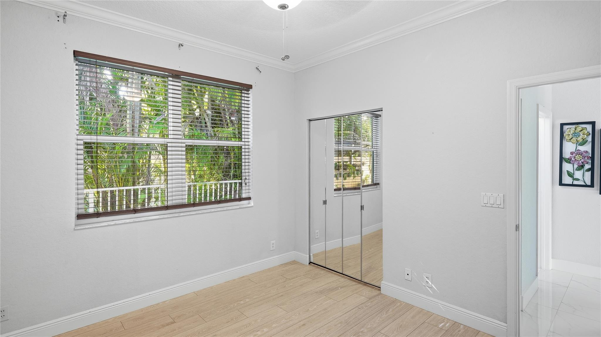 10141 Umberland Place Boca Raton, FL 33428 - Photo 21 of 26 an empty room with wooden floor and windows