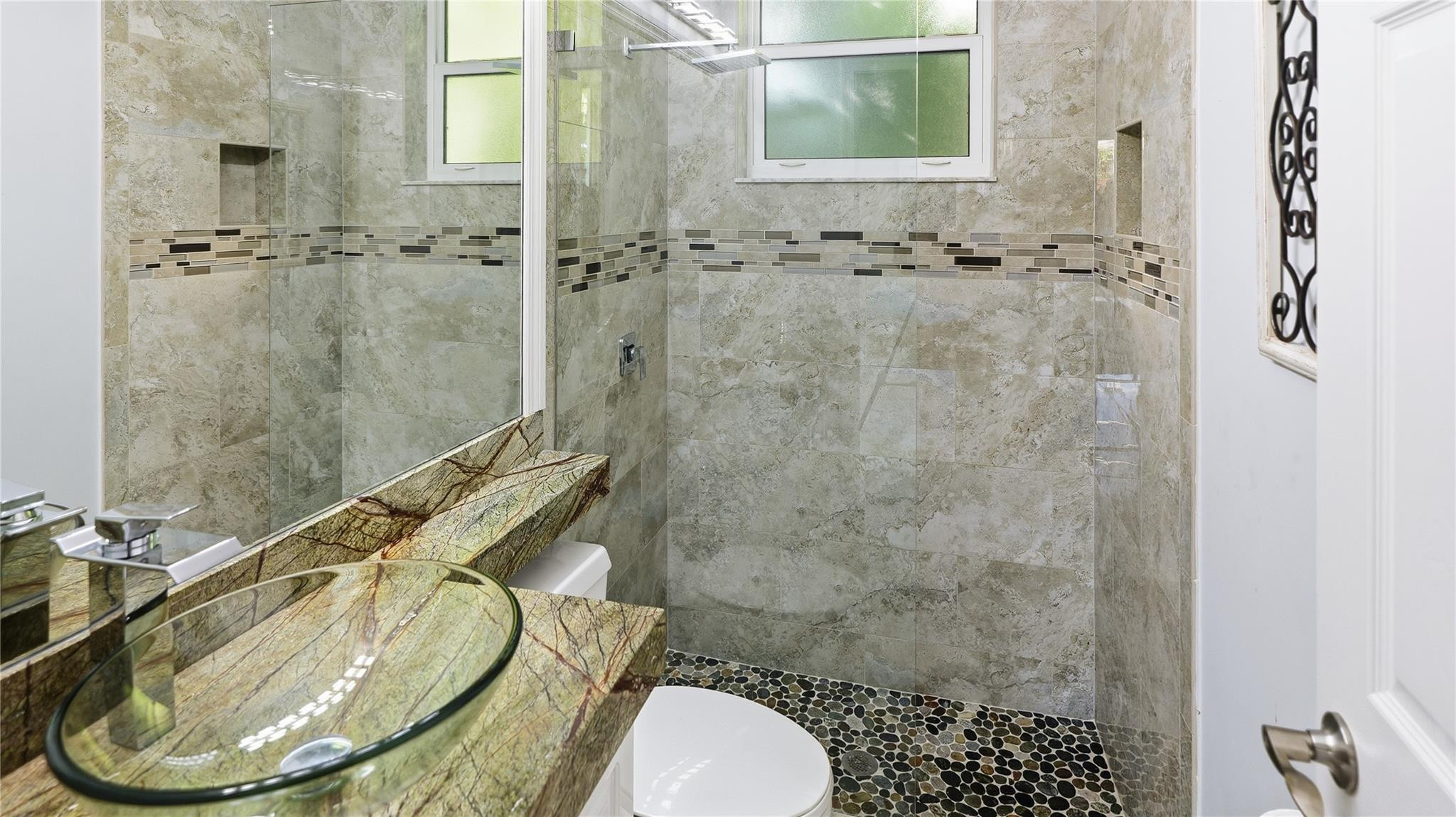 10141 Umberland Place Boca Raton, FL 33428 - Photo 22 of 26 a bathroom with a sink toilet and shower