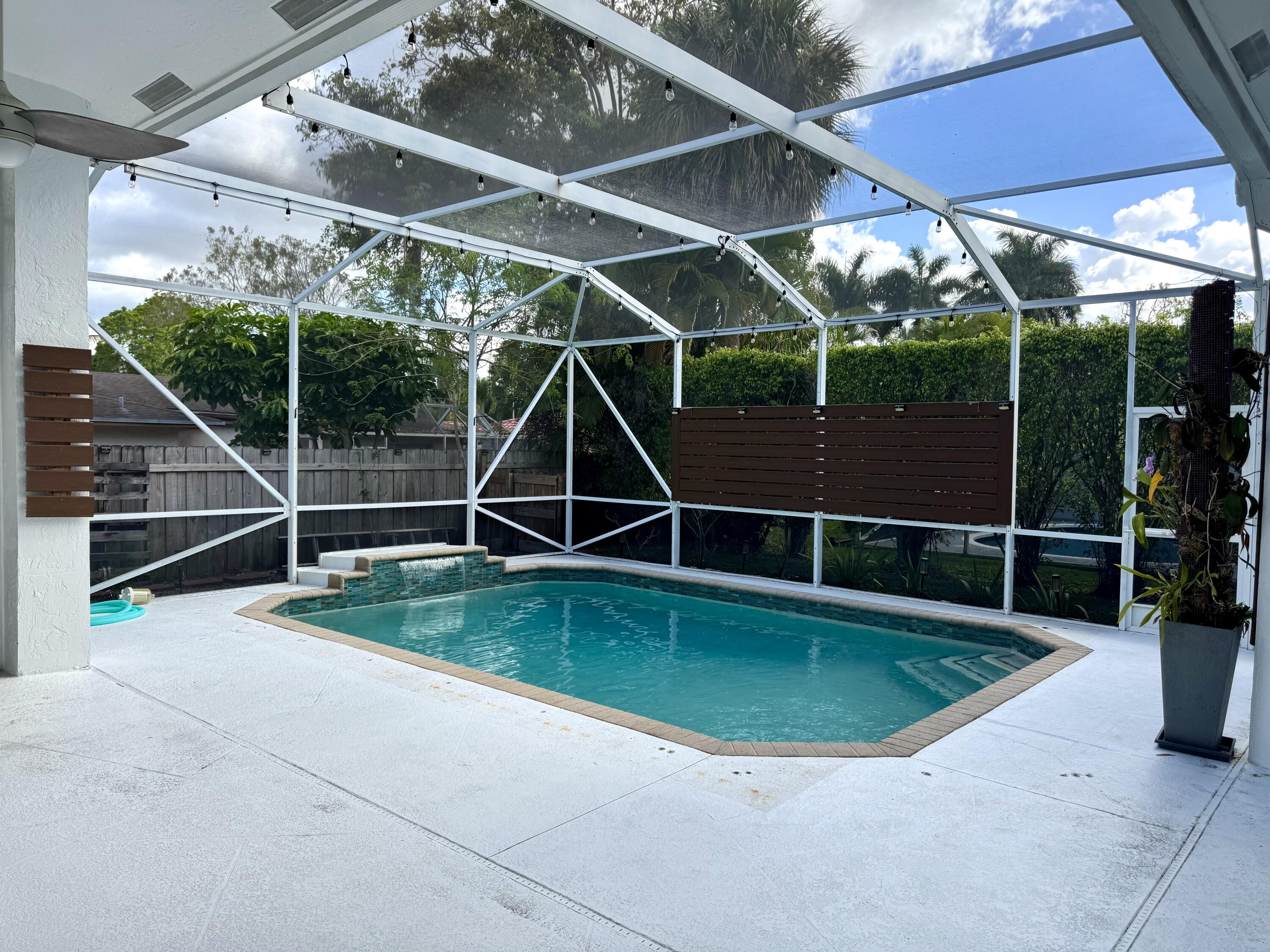 10141 Umberland Place Boca Raton, FL 33428 - Photo 5 of 26 a view of a swimming pool with a patio and a yard
