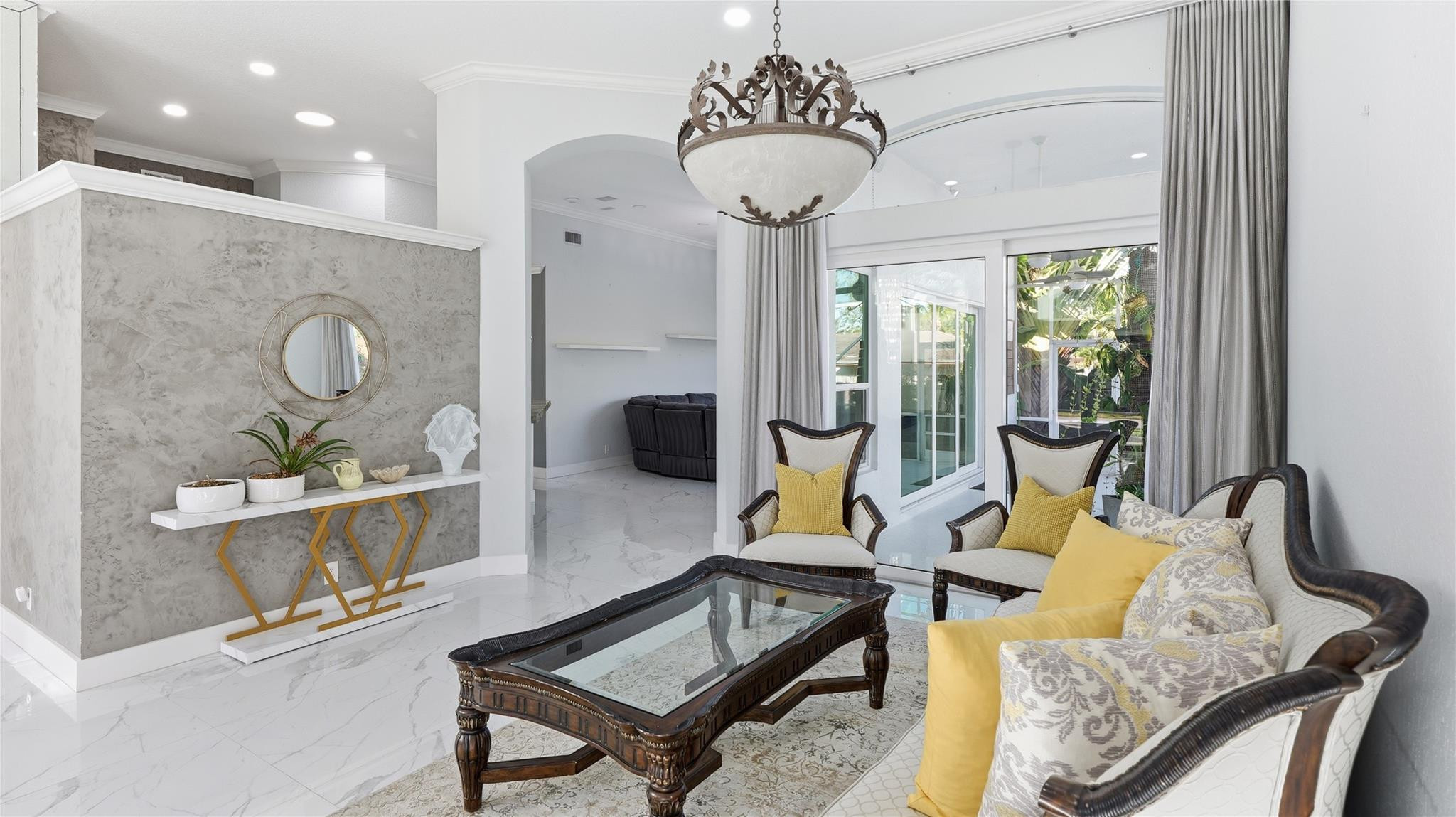 10141 Umberland Place Boca Raton, FL 33428 - Photo 8 of 26 a living room with furniture and a chandelier