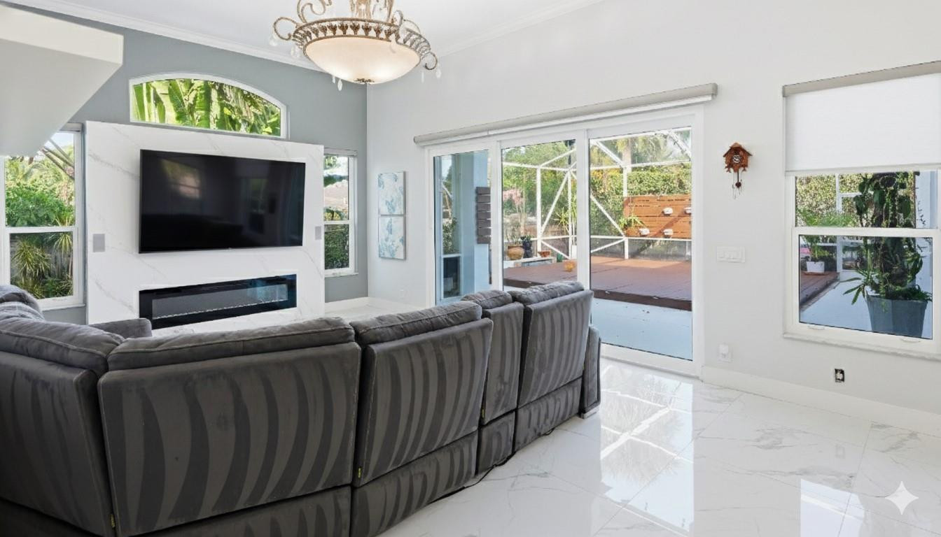 10141 Umberland Place Boca Raton, FL 33428 - Photo 9 of 26 a living room with furniture and a flat screen tv