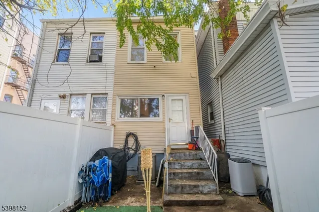 a view of a house with iron stairs