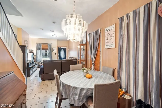 a view of a dining room with furniture and a chandelier