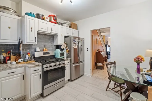 a kitchen with stainless steel appliances a stove a sink and cabinets