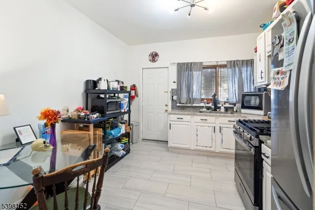 a kitchen with stainless steel appliances a stove a refrigerator and a refrigerator
