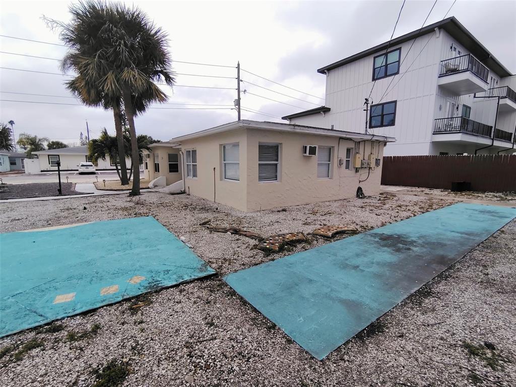115 145th Avenue, Unit 4 Madeira Beach, FL 33708 - Photo 11 of 11 a front view of a house with garden
