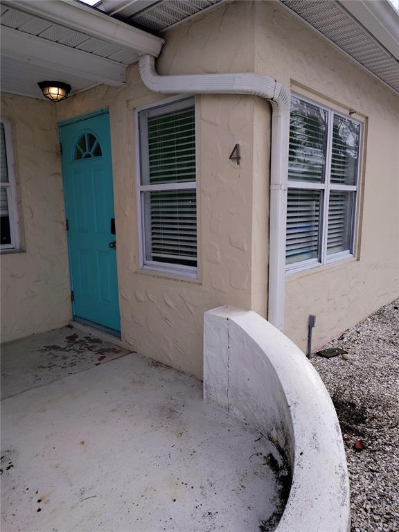 115 145th Avenue, Unit 4 Madeira Beach, FL 33708 - Photo 2 of 11 a view of a livingroom with a staircase