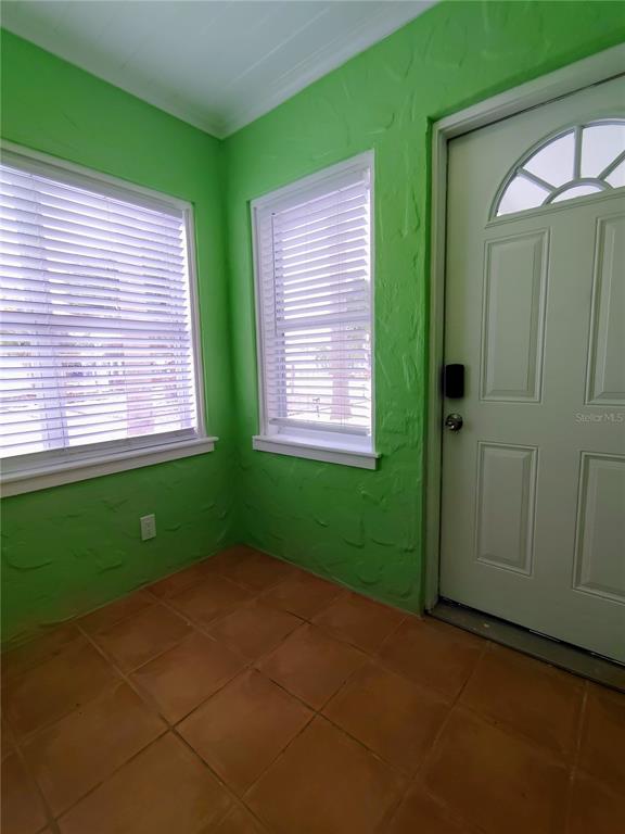 115 145th Avenue, Unit 4 Madeira Beach, FL 33708 - Photo 3 of 11 a view of an empty room with window and stairs