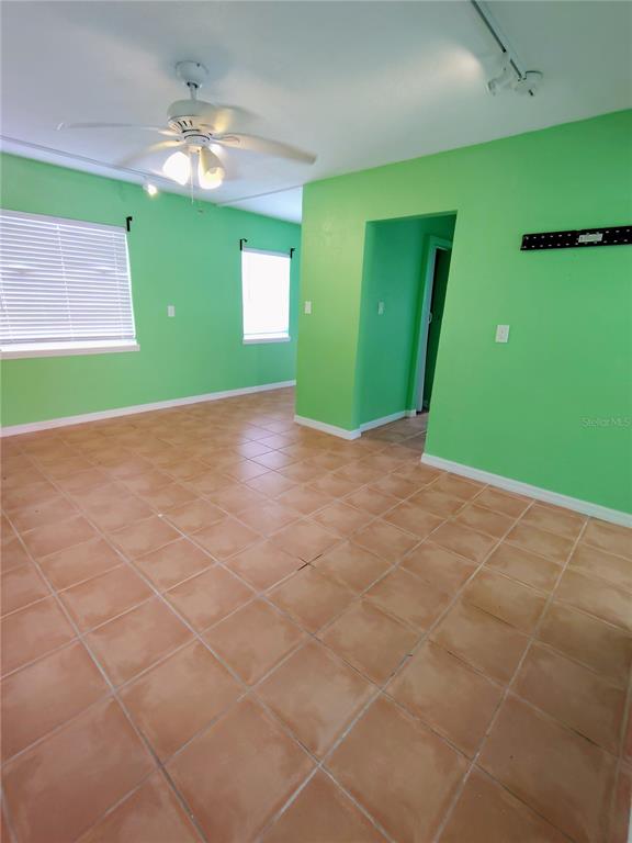 115 145th Avenue, Unit 4 Madeira Beach, FL 33708 - Photo 5 of 11 a view of a room that has a fan and window