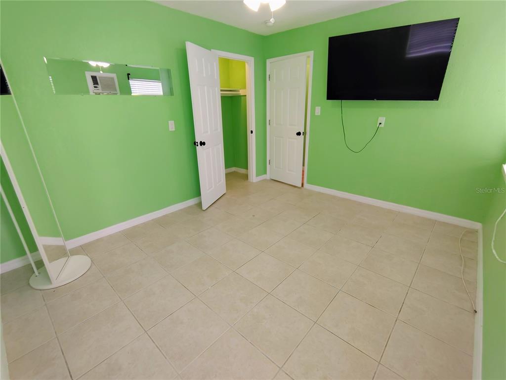 115 145th Avenue, Unit 4 Madeira Beach, FL 33708 - Photo 8 of 11 a view of a room with a flat screen tv
