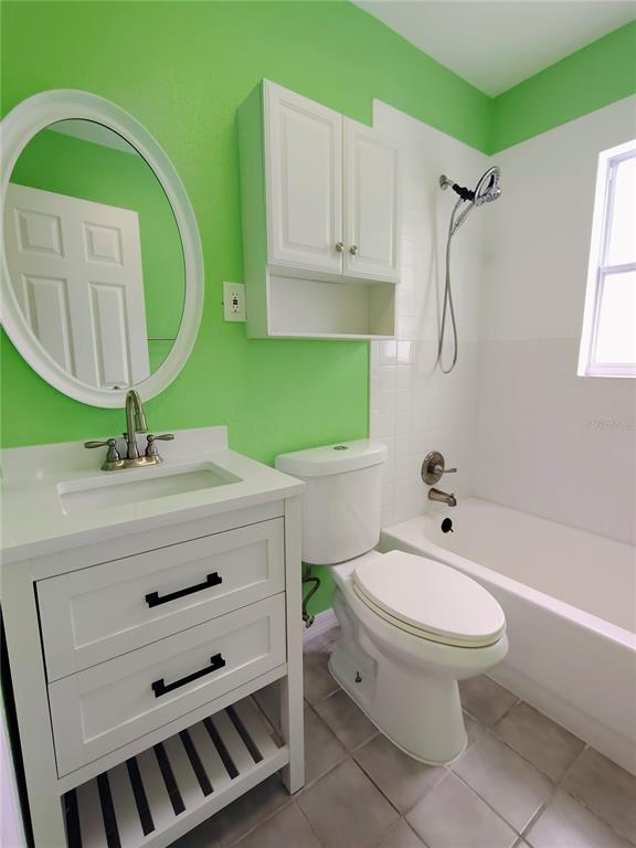 115 145th Avenue, Unit 4 Madeira Beach, FL 33708 - Photo 9 of 11 a bathroom with a sink toilet and a mirror
