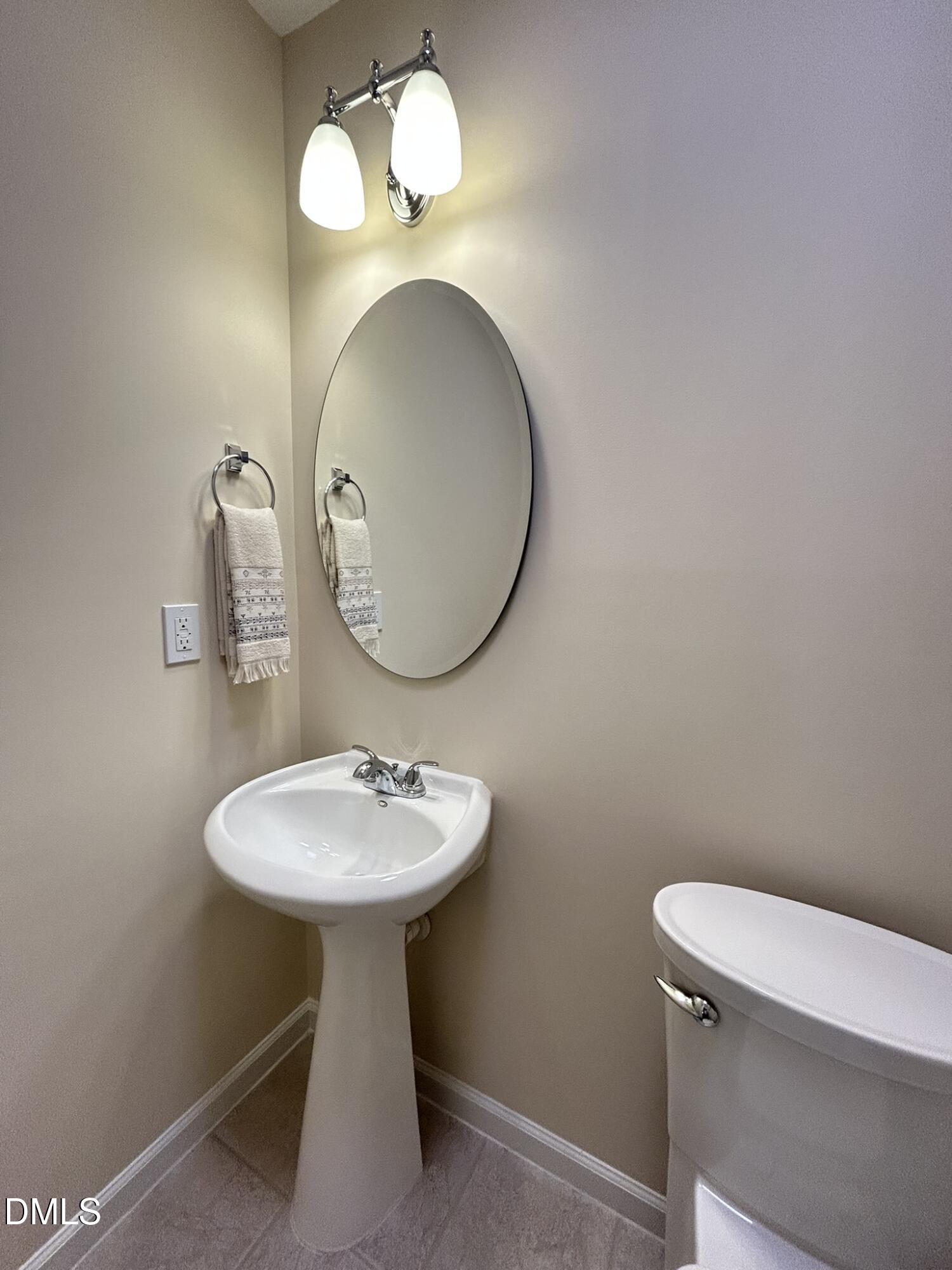 2510 Friedland Place, Unit 102 Raleigh, NC 27617 - Photo 19 of 42 a bathroom with a toilet sink and mirror