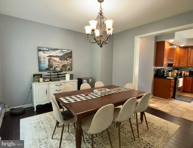 a view of a dining room with furniture and chandelier