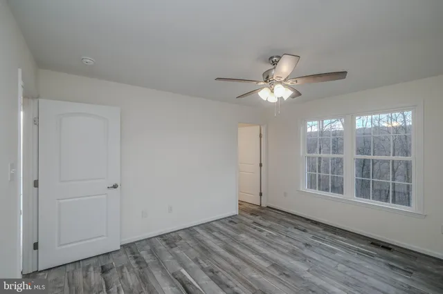 a view of a balcony with wooden floor and fence