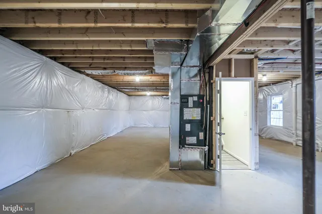 a view of backyard with wooden fence and large trees