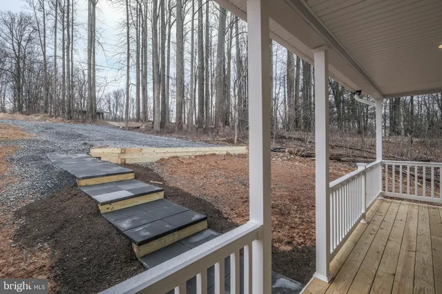 a view of a porch with a table and chairs