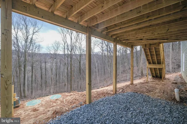 a front view of a house with a garden and lake view