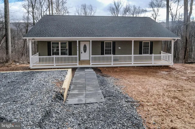 a front view of a building with a garden