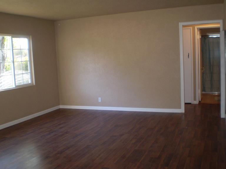 1013 Layton Road Redding, CA 96002 - Photo 8 of 15 an empty room with wooden floor and windows