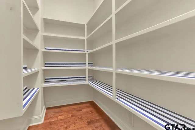 a bathroom with white cabinets and a sink
