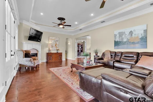 a kitchen with stainless steel appliances kitchen island granite countertop a stove and white cabinets