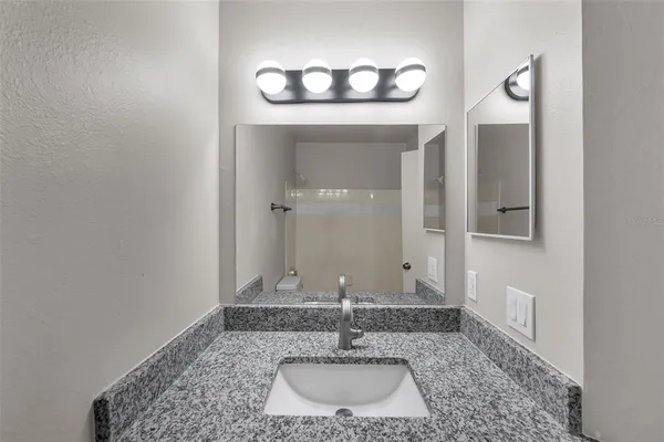 a bathroom with a sink and a mirror