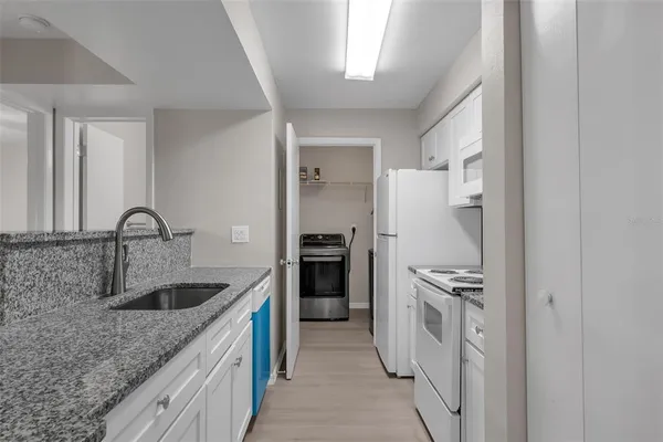 a kitchen with a sink and a refrigerator