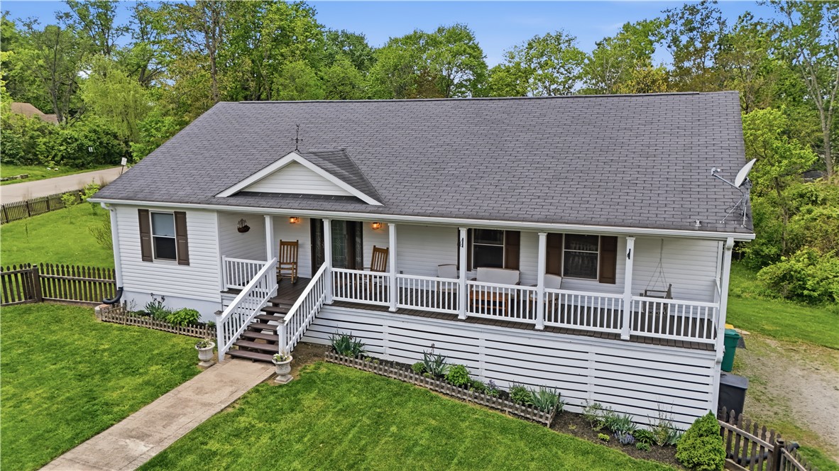 1208 Jarva Lane Springboro, OH 45066 - Photo 2 of 75 This charming home features a welcoming porch, lush green lawn, and mature trees, perfect for tranquil living.
