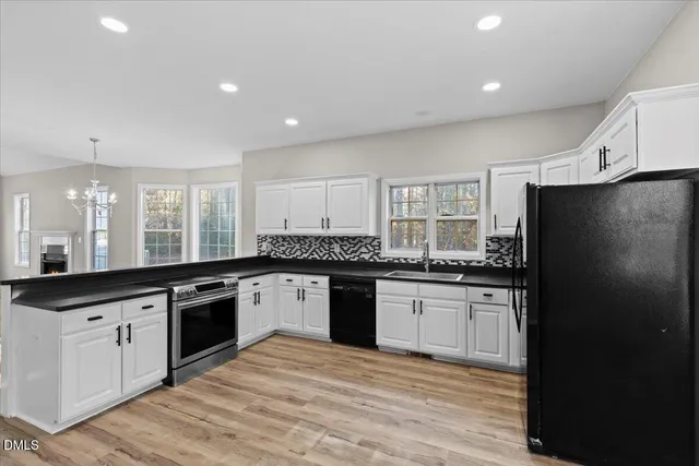 a large kitchen with stainless steel appliances granite countertop a stove a sink and a refrigerator