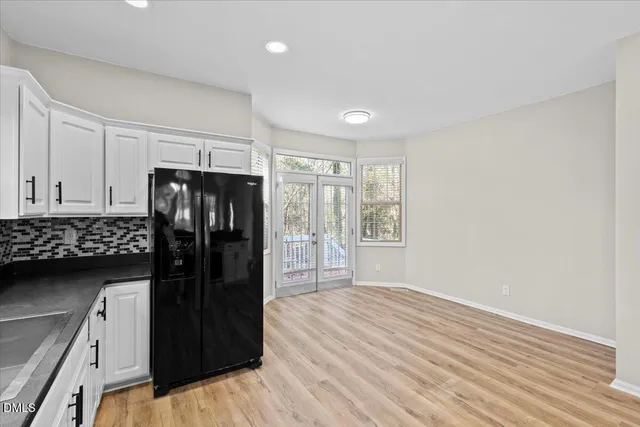 a view of a refrigerator in kitchen and wooden floor
