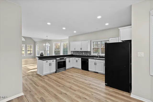 a kitchen with a refrigerator and a stove top oven