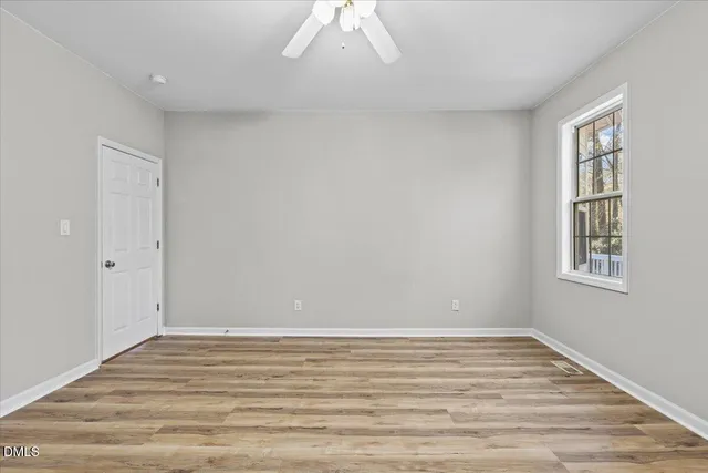 a view of a room with wooden floor and windows