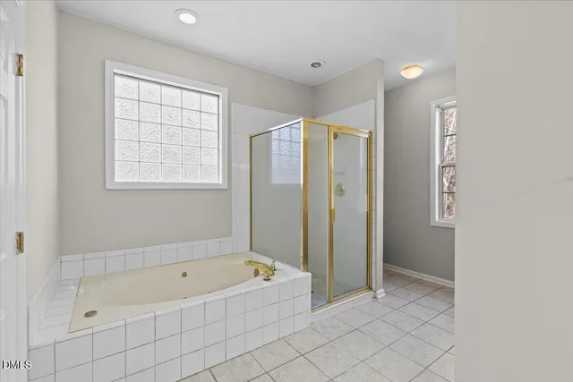 a bathroom with a bathtub and a shower