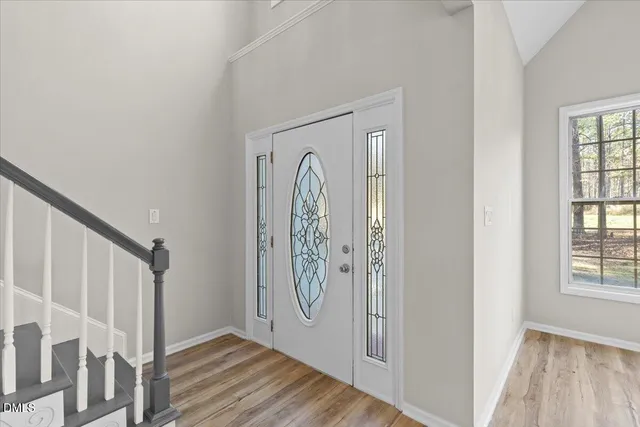 a view of front door with wooden floor