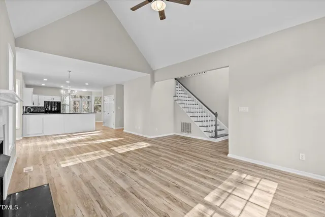 a view of a kitchen with kitchen island wooden floor and ceiling fan