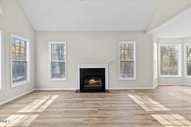 a view of a livingroom with a fireplace window and outside view