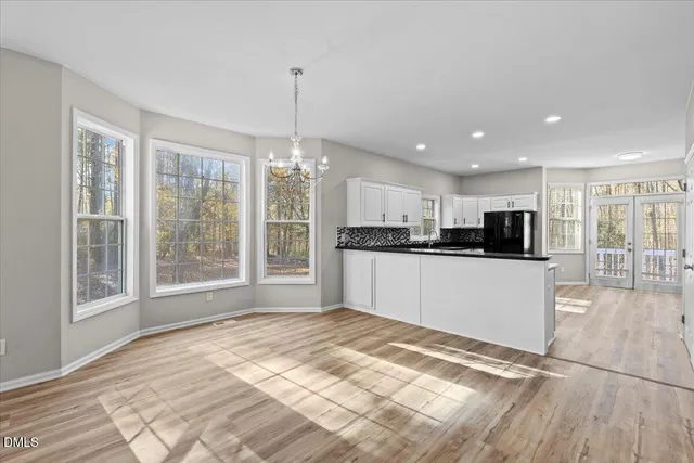 a view of a kitchen with kitchen island a counter top space appliances and cabinets