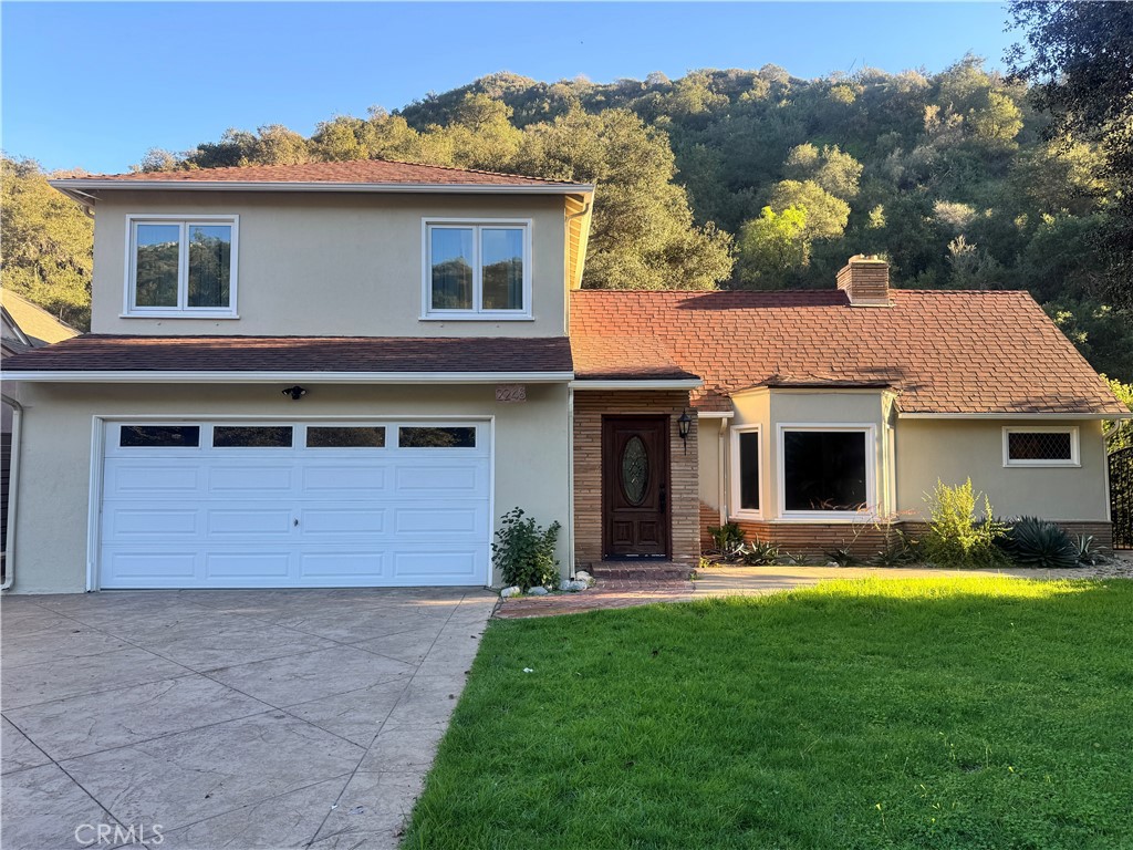 2248 East Chevy Chase Drive Glendale, CA 91206 - Photo 1 of 25 a front view of a house with a yard and garage