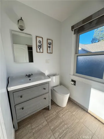 a bathroom with a sink mirror and toilet