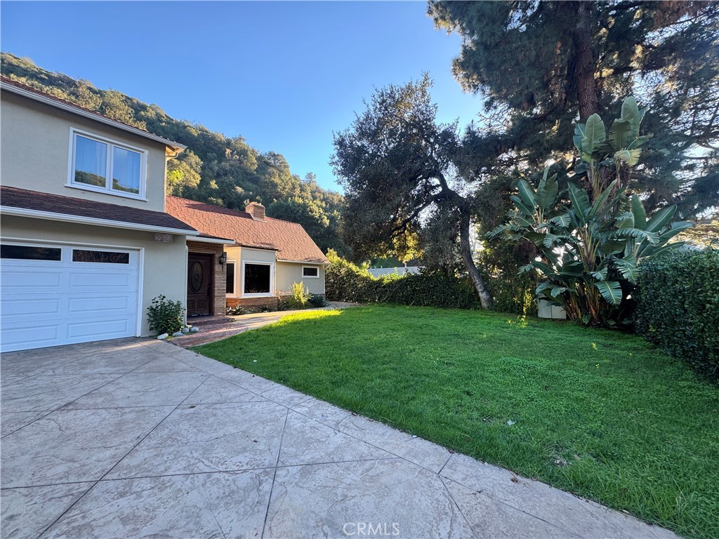 2248 East Chevy Chase Drive Glendale, CA 91206 - Photo 2 of 25 a front view of a house with garden