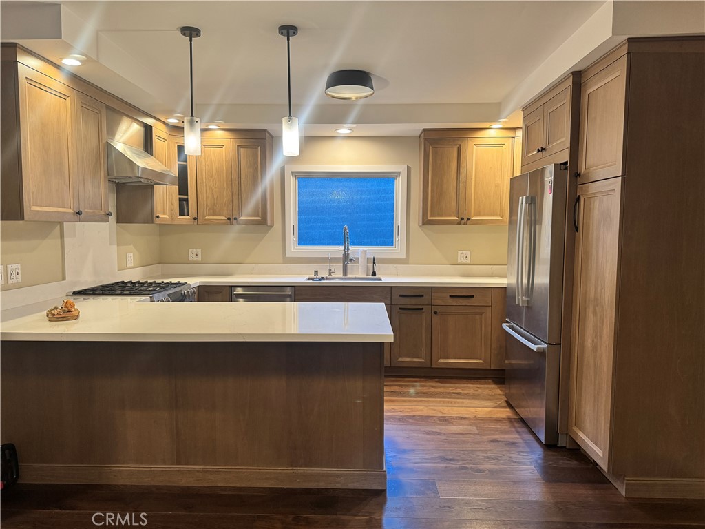 2248 East Chevy Chase Drive Glendale, CA 91206 - Photo 3 of 25 a kitchen with kitchen island granite countertop a sink appliances and cabinets