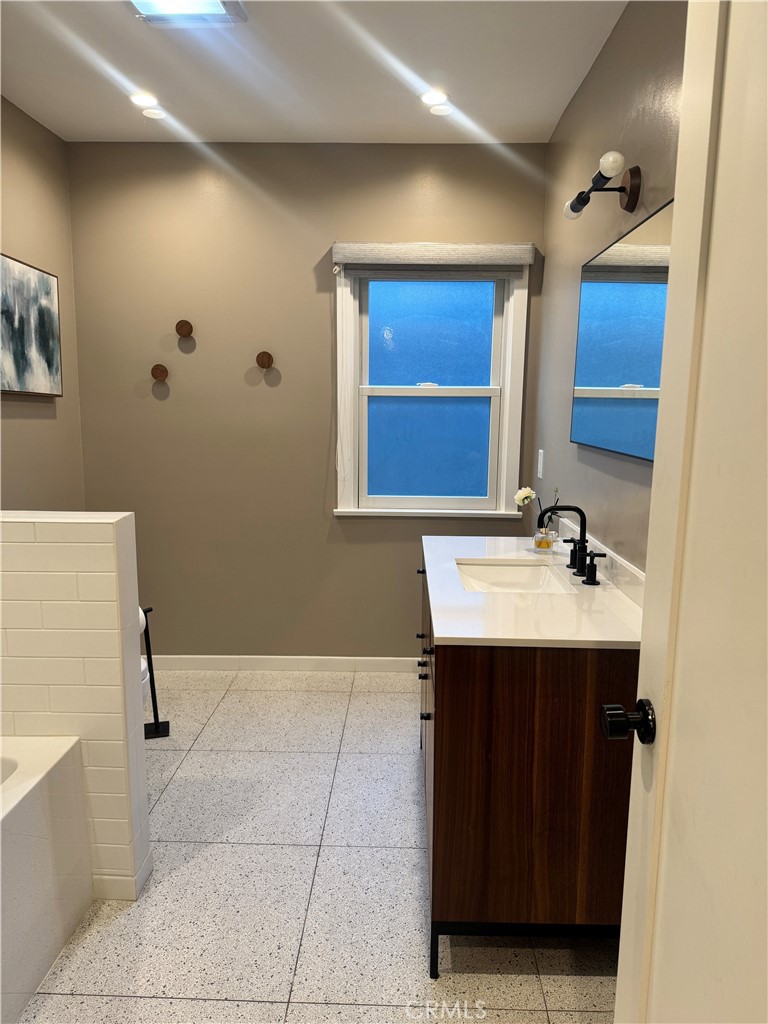 2248 East Chevy Chase Drive Glendale, CA 91206 - Photo 5 of 25 a bathroom with a sink and a mirror