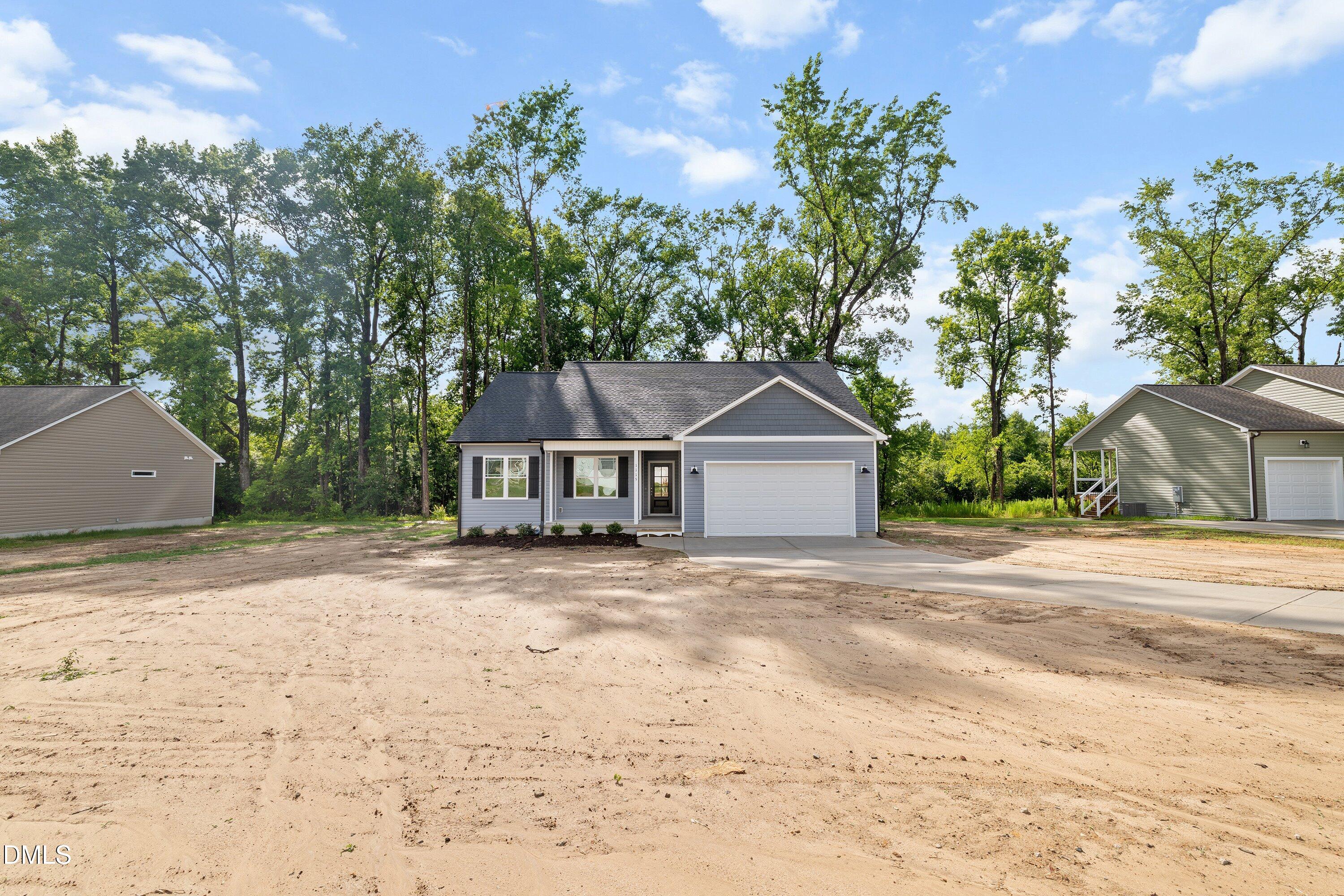 1115 Nor-Am Road Pikeville, NC 27863 - Photo 6 of 40 a front view of a house with a yard and a garage